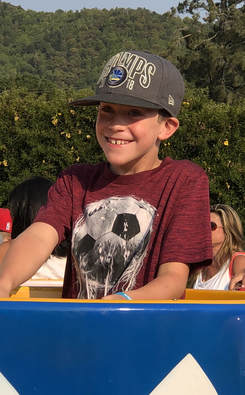 boy in a teacup at the fair
